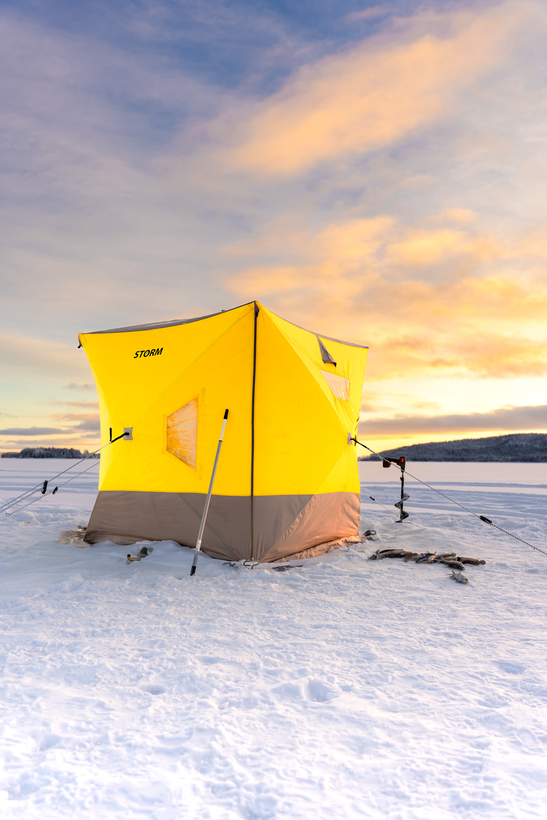 Snow-covered cabin in golden light